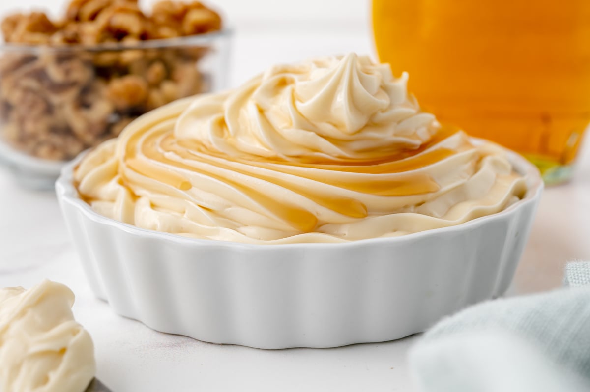 close up maple syrup on mound of white frosting