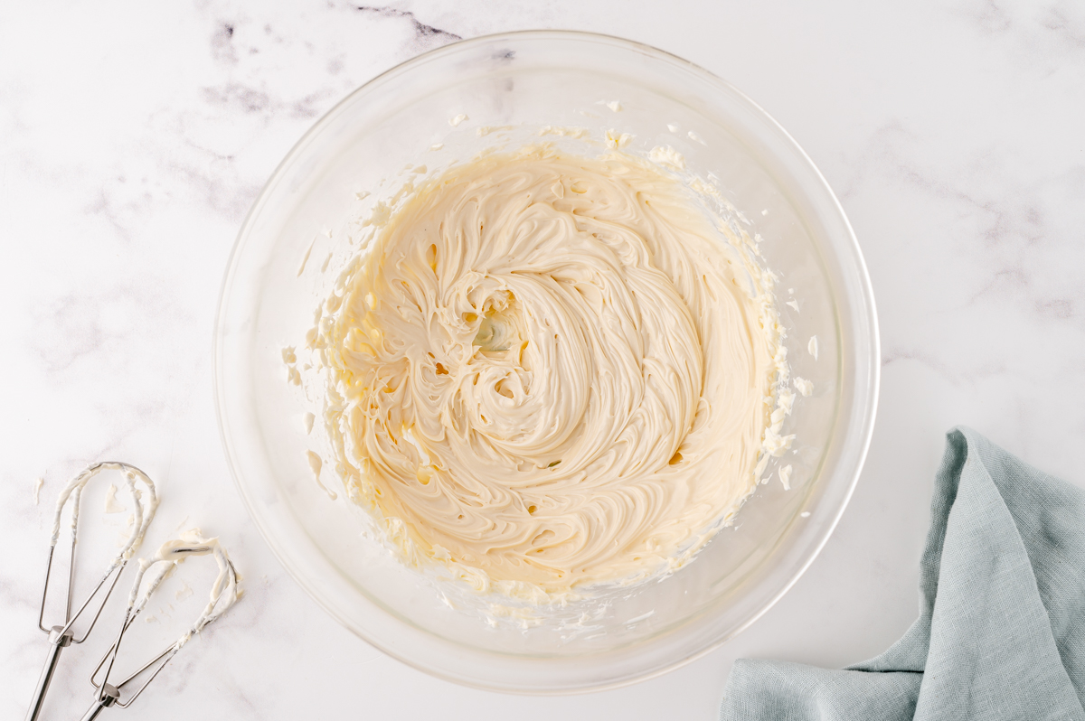 maple cream cheese frosting in a glass mixing bowl