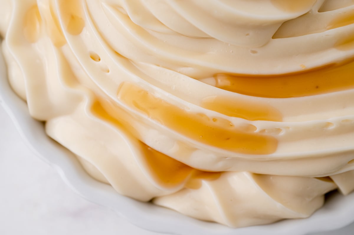 close up maple syrup dripping on frosting swirl