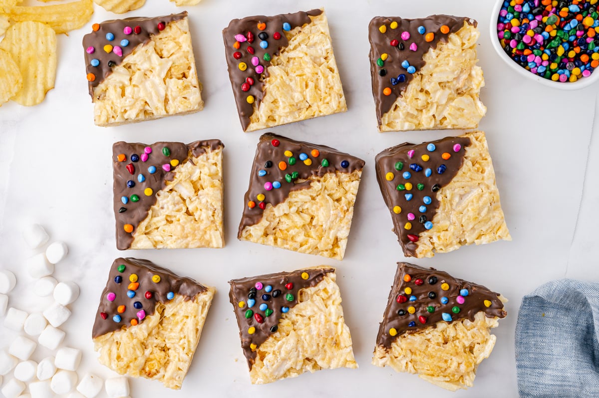 overhead of 9 potato chips bars with chocolate and rainbow chips