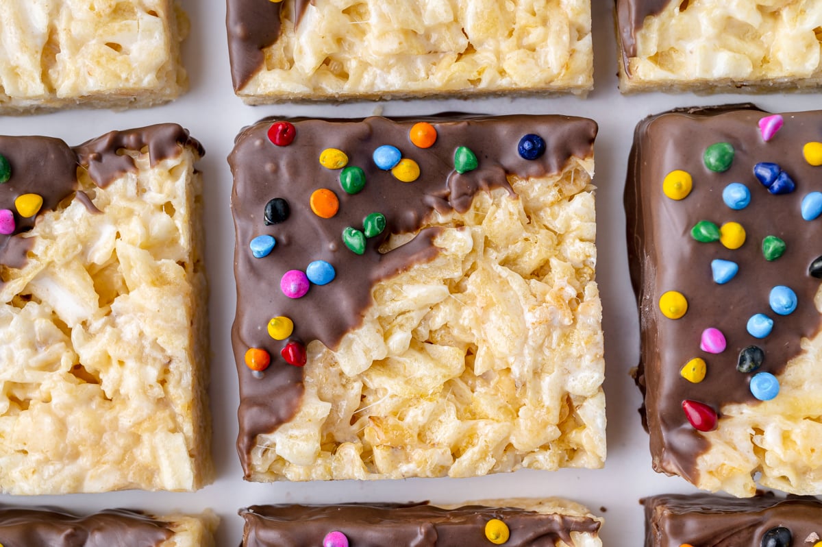 close up of potato chip marshmallow treats dipped in chocolate with rainbow chips