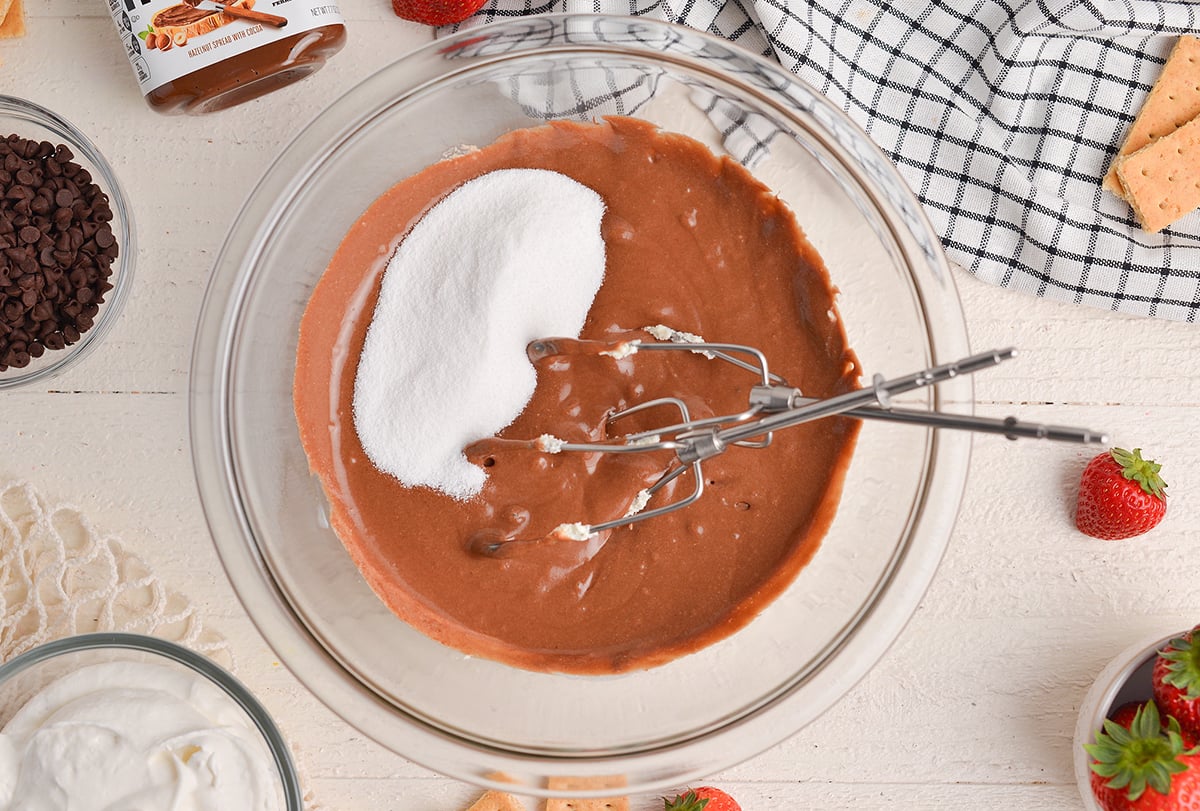 sugar in bowl of chocolate dip with beaters