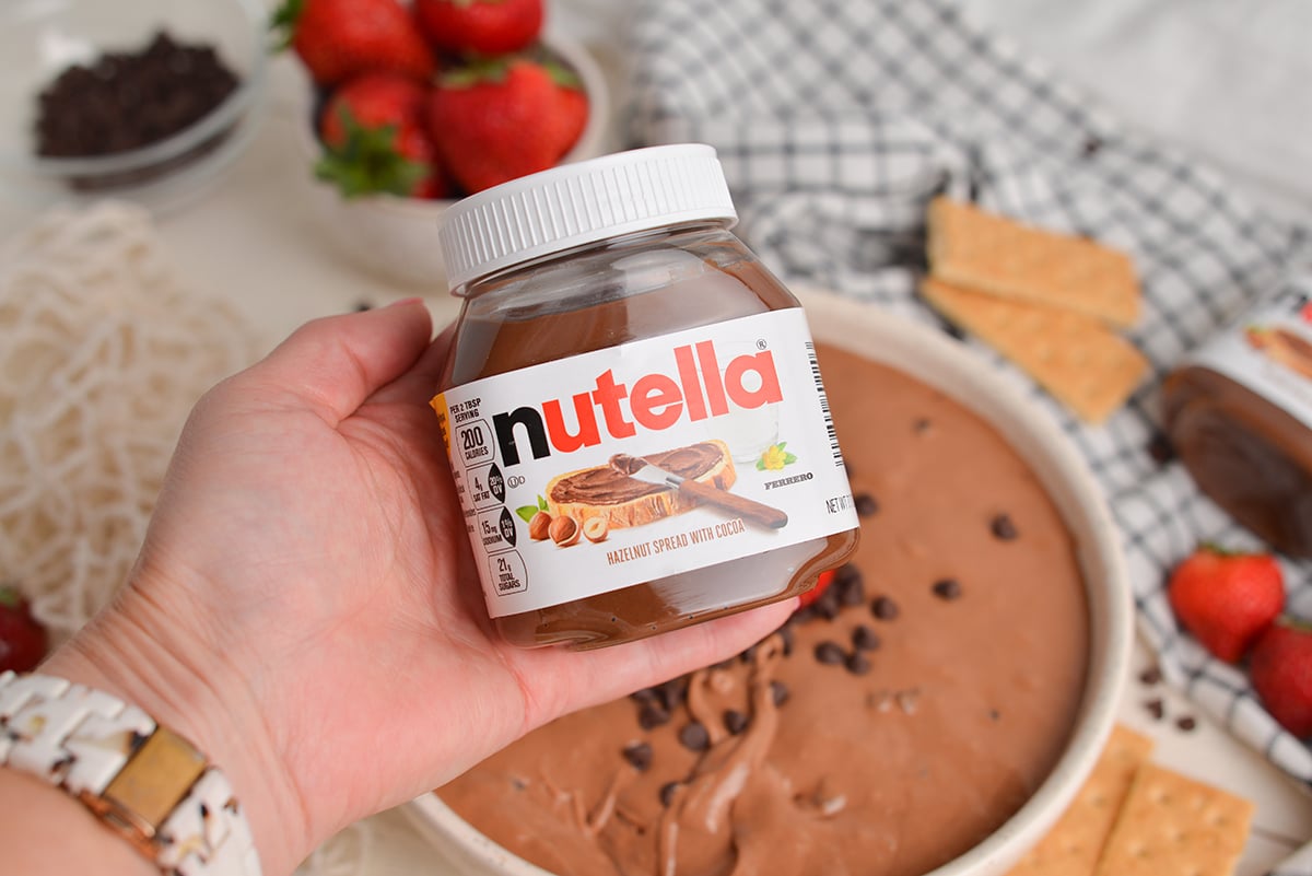 hand holding jar of nutella