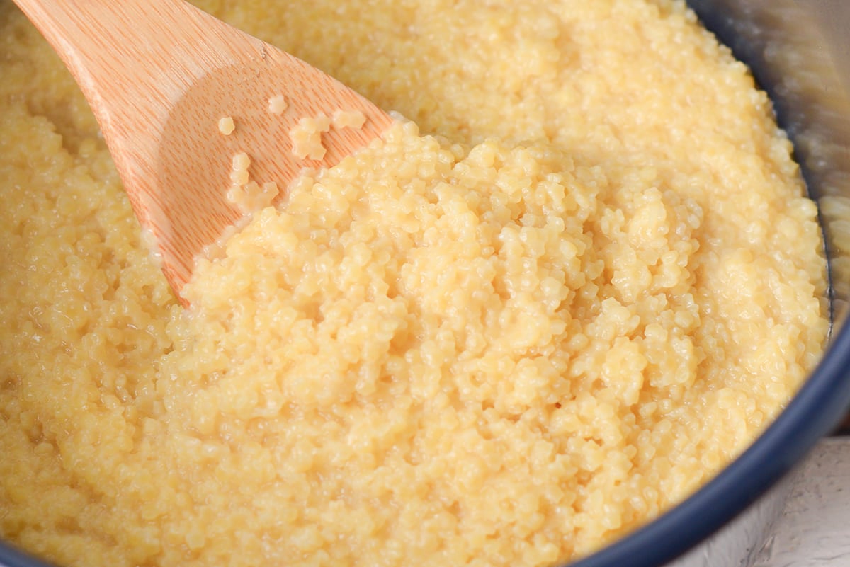 wooden spoon close up with creamy pastina pasta