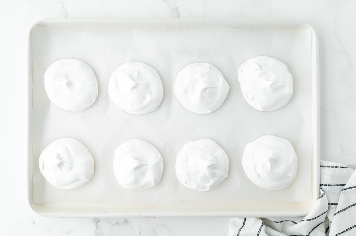 overhead shot of piles of meringue on baking sheet