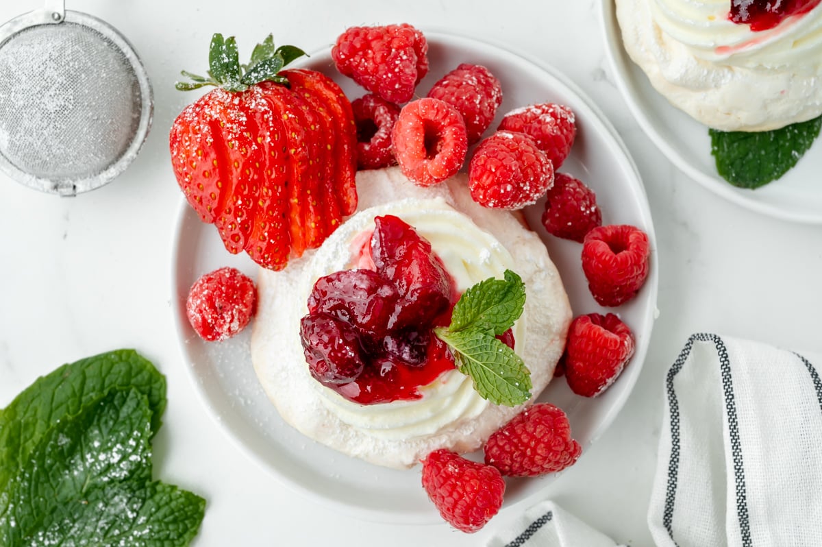 overhead shot of pavlova on plate with berries