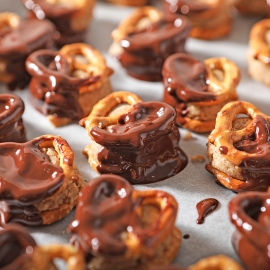 melted chocolate on peanut butter pretzel sandwiches