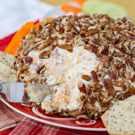 angled shot of knife in pineapple ham cheese ball