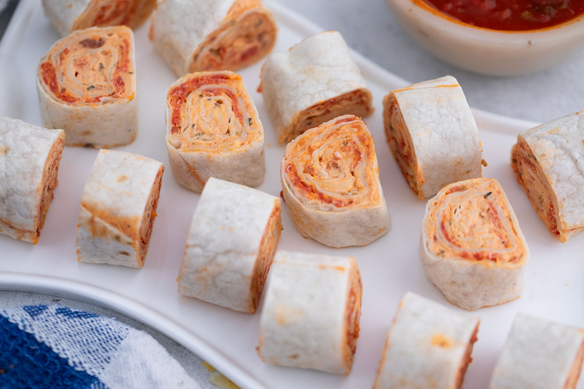 overhead shot of pizza pinwheels on tray