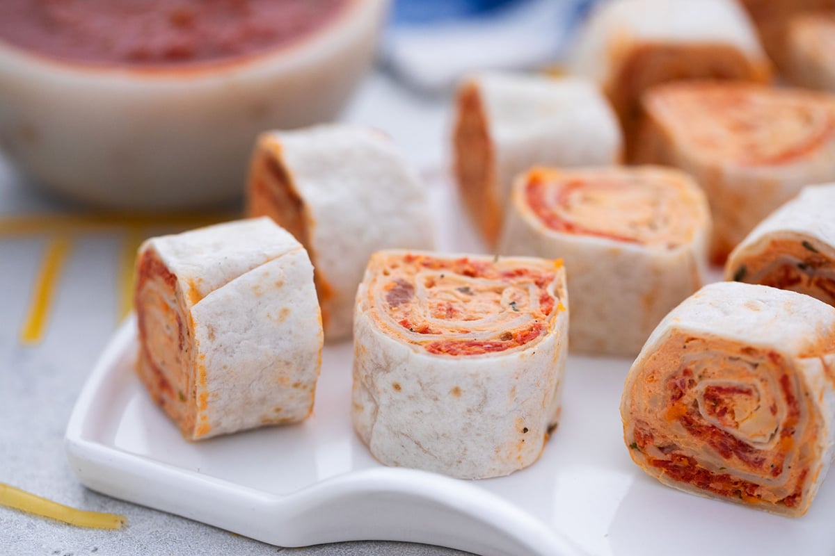 close up angled shot of pizza pinwheels on plate