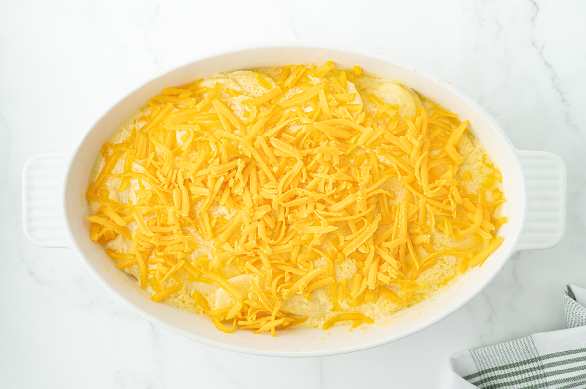 overhead shot of shredded cheese sprinkled over potatoes