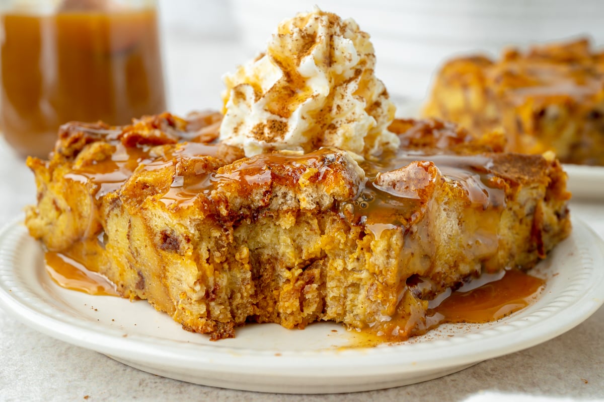 close up shot of bite taken out of slice of pumpkin bread pudding