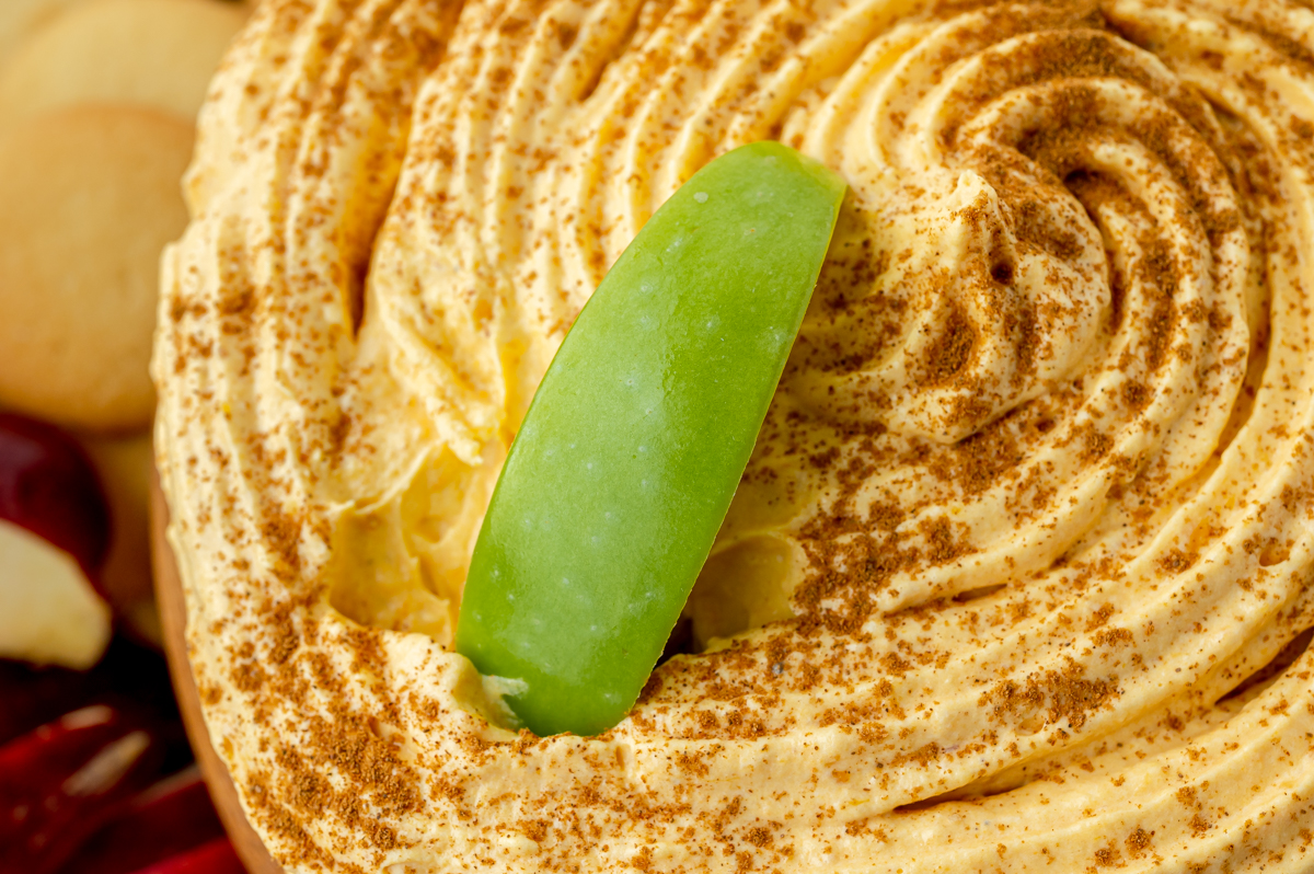 close up shot of green apple slice in pumpkin fluff