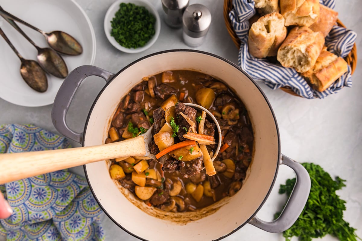 overhead shot of ladle full of beef stew