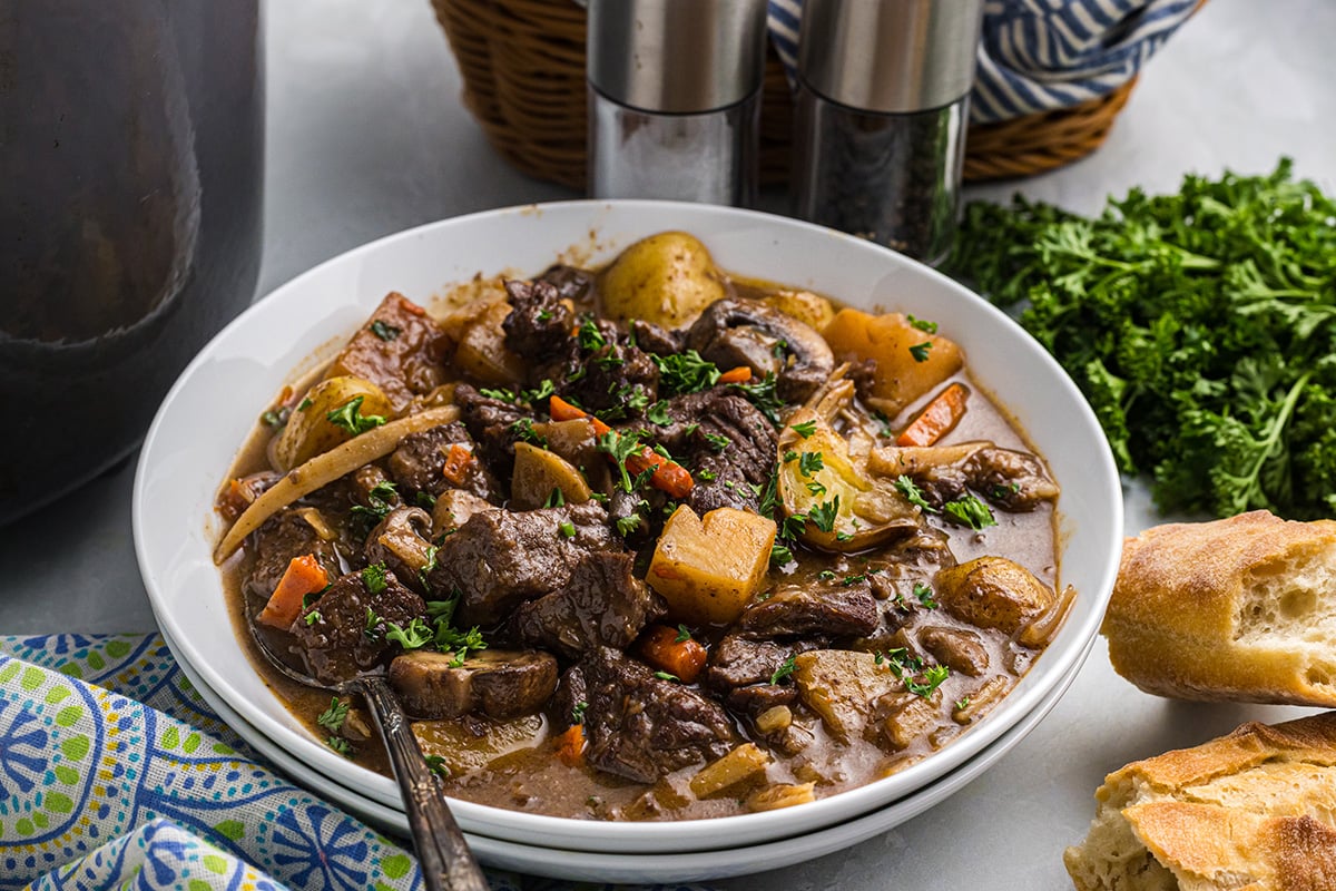 angled shot of bowl of red wine beef stew