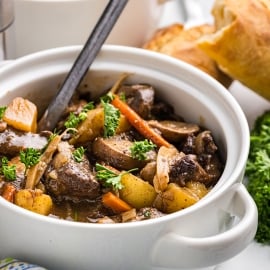 angled shot of spoon on crock pot beef stew