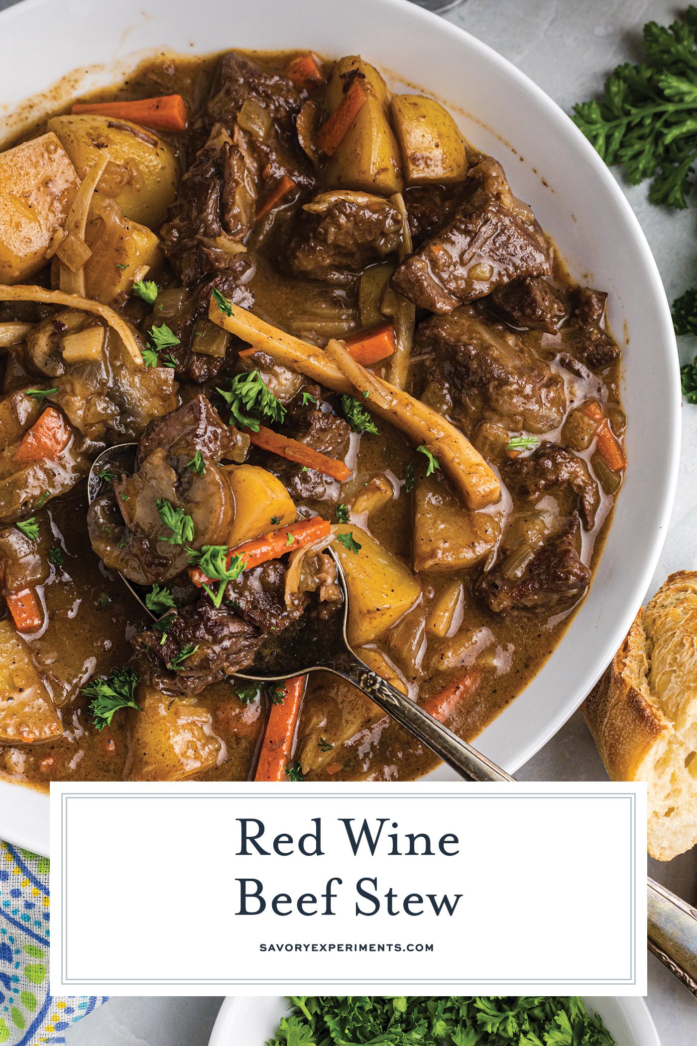 spoon in bowl of red wine beef stew with text overlay for pinterest