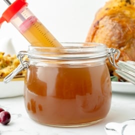 straight on shot of syringe in jar of turkey injection