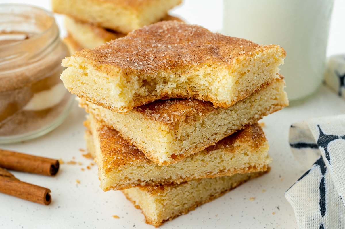 angled shot of bite taken out of stack of snickerdoodle bars