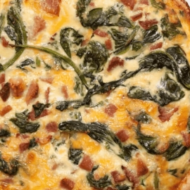 overhead shot of spinach, ham and cheddar quiche