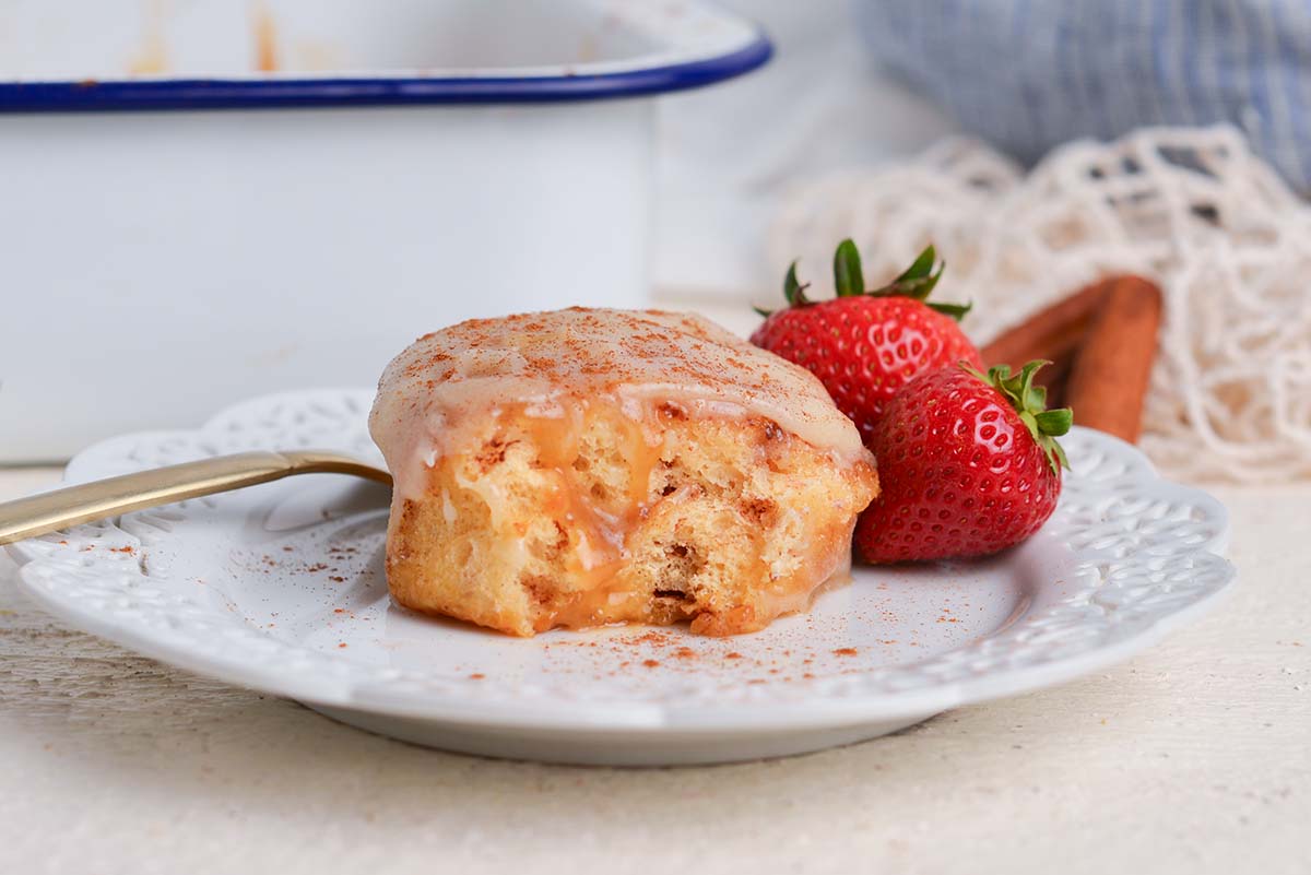 straight on shot of tiktok cinnamon roll on plate with strawberries