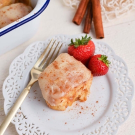 angled shot of tiktok cinnamon roll on plate with strawberries