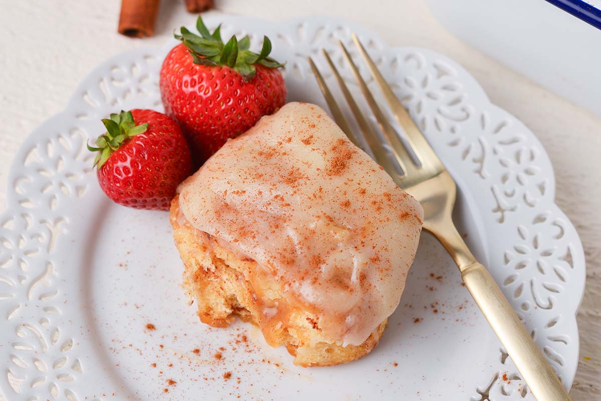 close up overhead shot of tiktok cinnamon roll on plate with strawberries