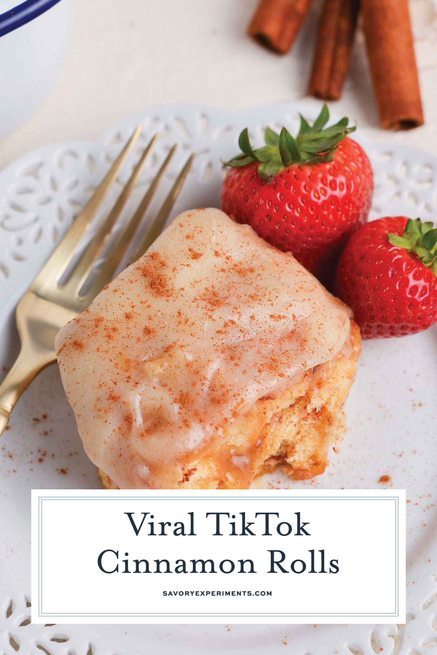 angled shot of tiktok cinnamon roll on plate with text overlay for pinterest