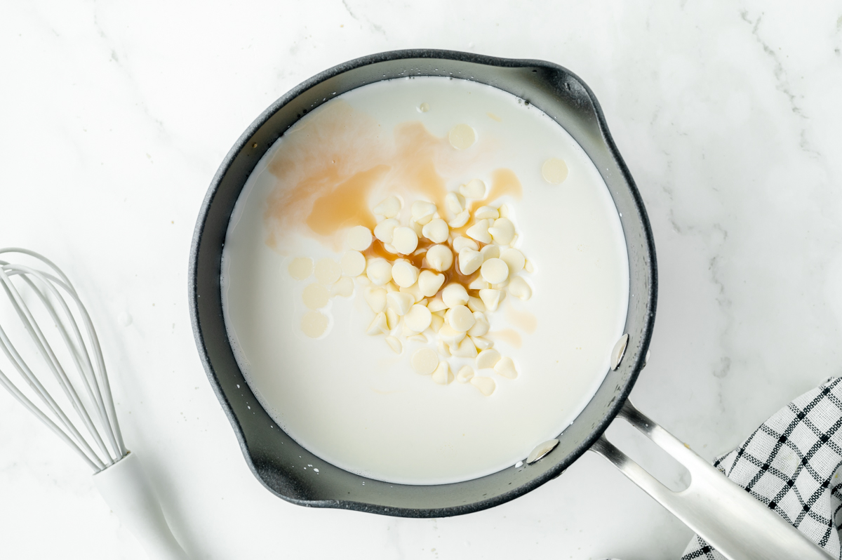 overhead shot of white chocolate and vanilla in pan of milk