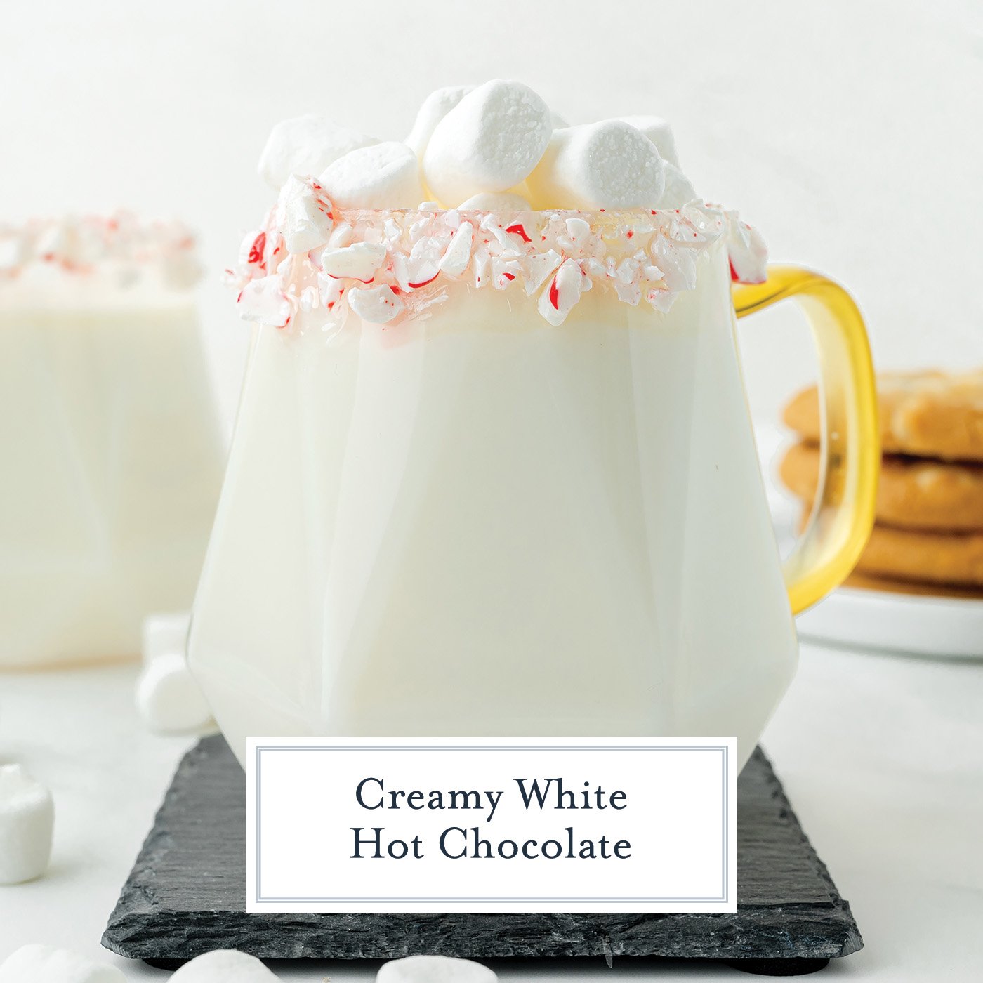 straight on shot of mug of white hot chocolate with text overlay for facebok