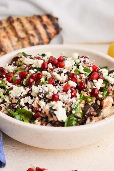 angled shot of wild rice salad in white bowl