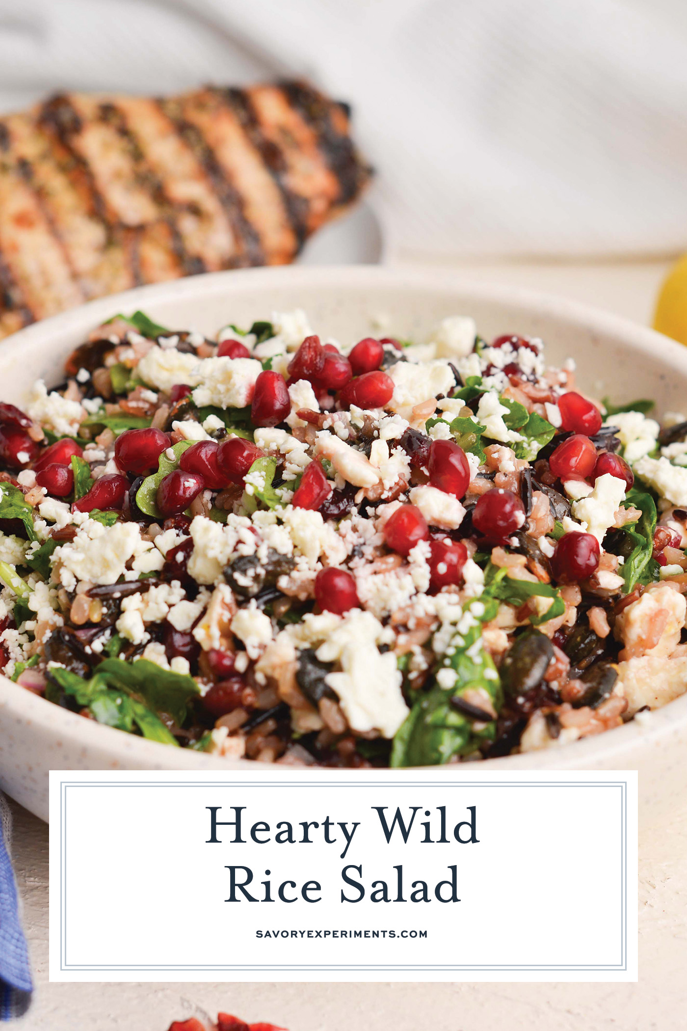 close up angled shot of wild rice salad in bowl with text overlay for pinterest