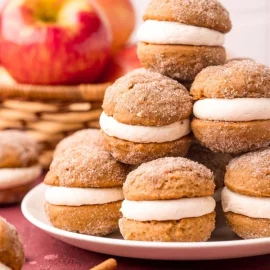 straight on shot of stack of apple cider whoopie pies on plate