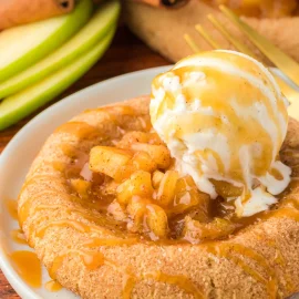 angled shot of apple pie cookie topped with ice cream