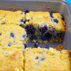 angled shot of slice taken out of blueberry cornbread