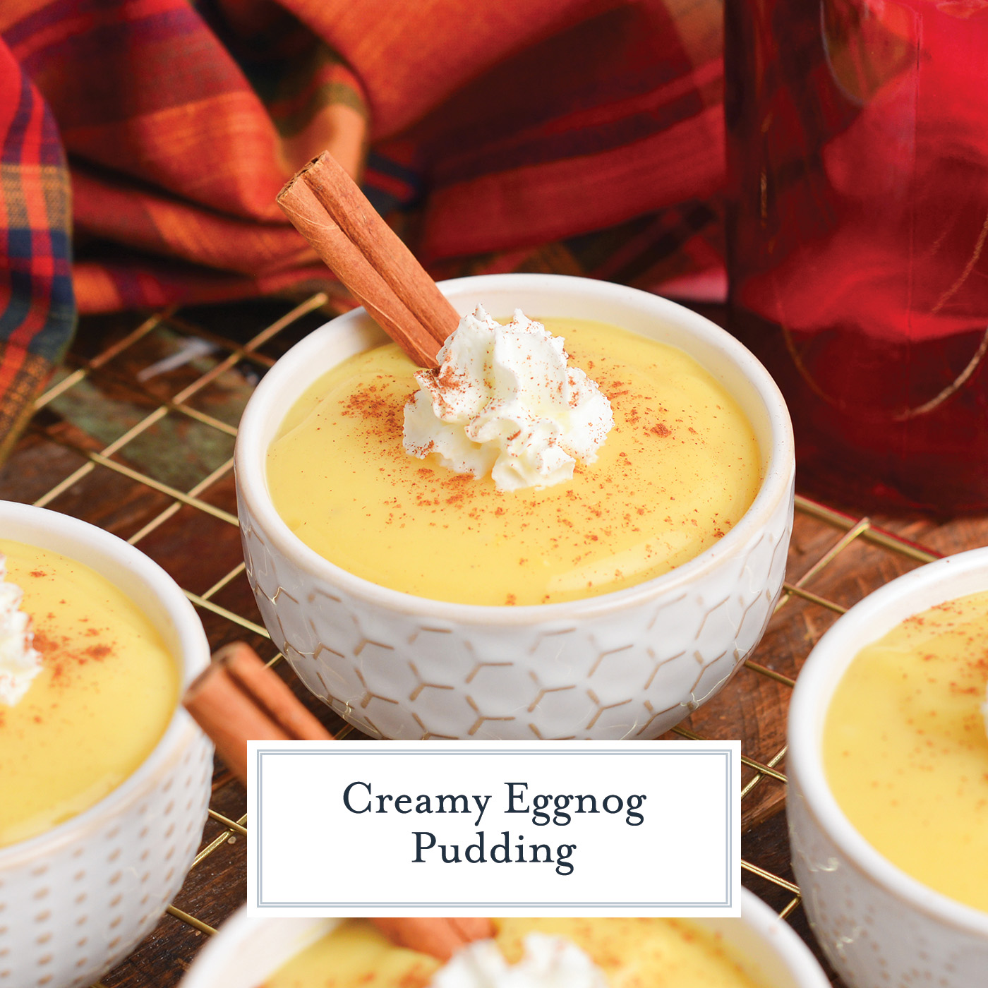 angled shot of eggnog pudding with whipped cream and cinnamon stick with text overlay for facebook