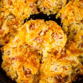 overhead shot of skillet of ham and cheese biscuits