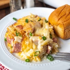 angled shot of ham and cheese hash brown casserole on plate