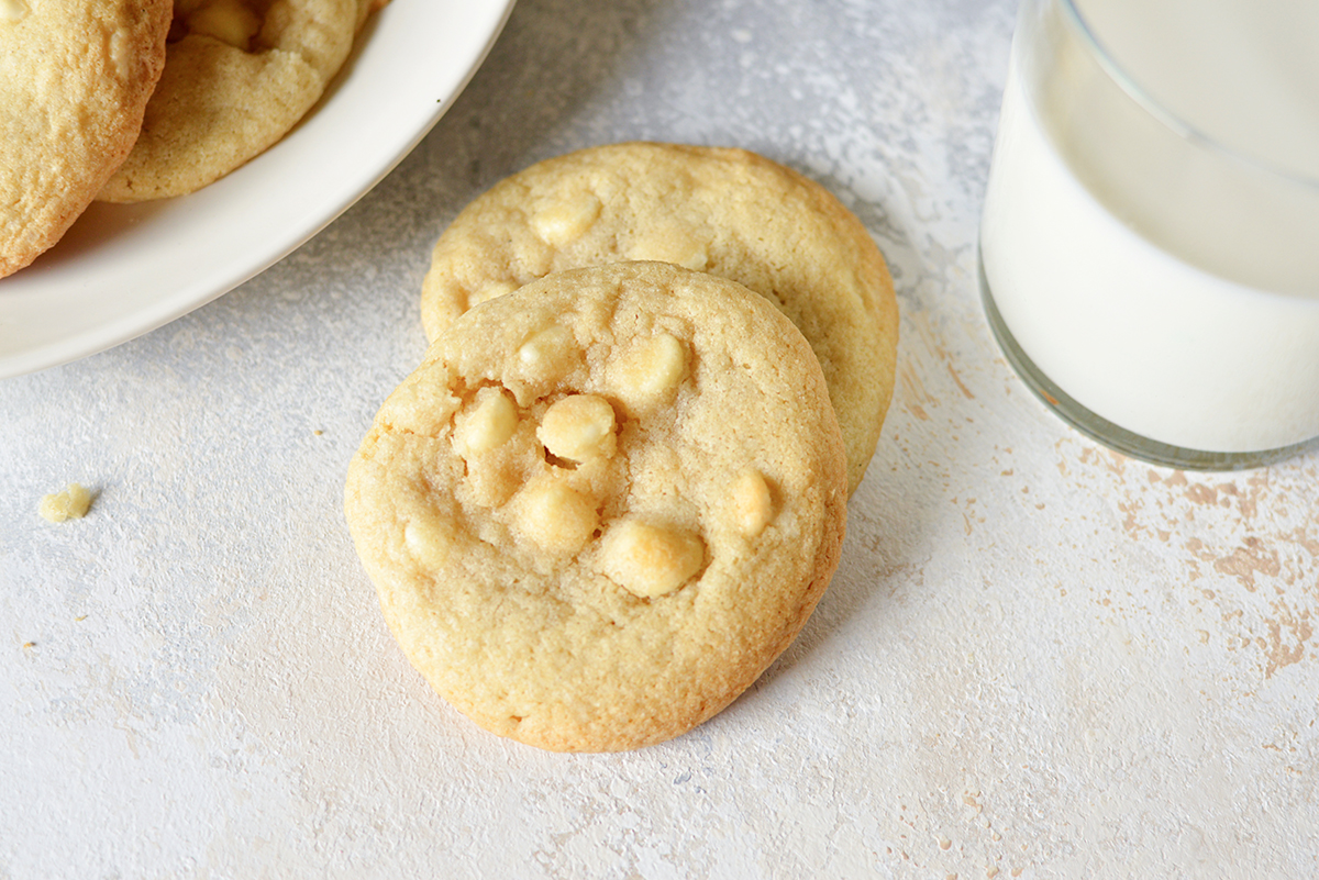 overhead image of white chocolate chip cookies on a white background
