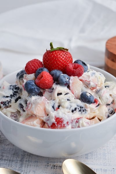 angled shot of berry cheesecake salad in bowl
