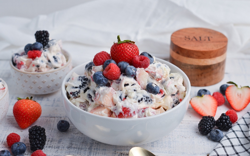 angled shot of berry cheesecake salad in bowl