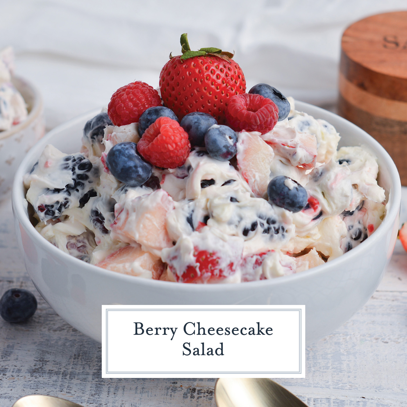 angled shot of bowl of berry cheesecake salad with text overlay for facebook