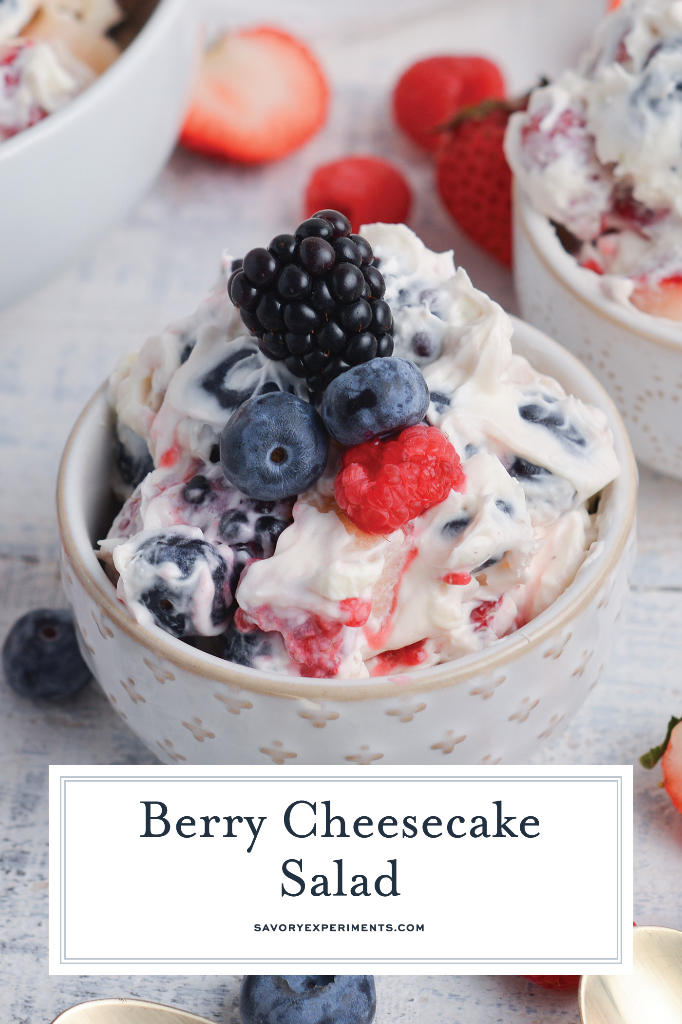 angled shot of bowl of berry cheesecake salad with text overlay for pinterest
