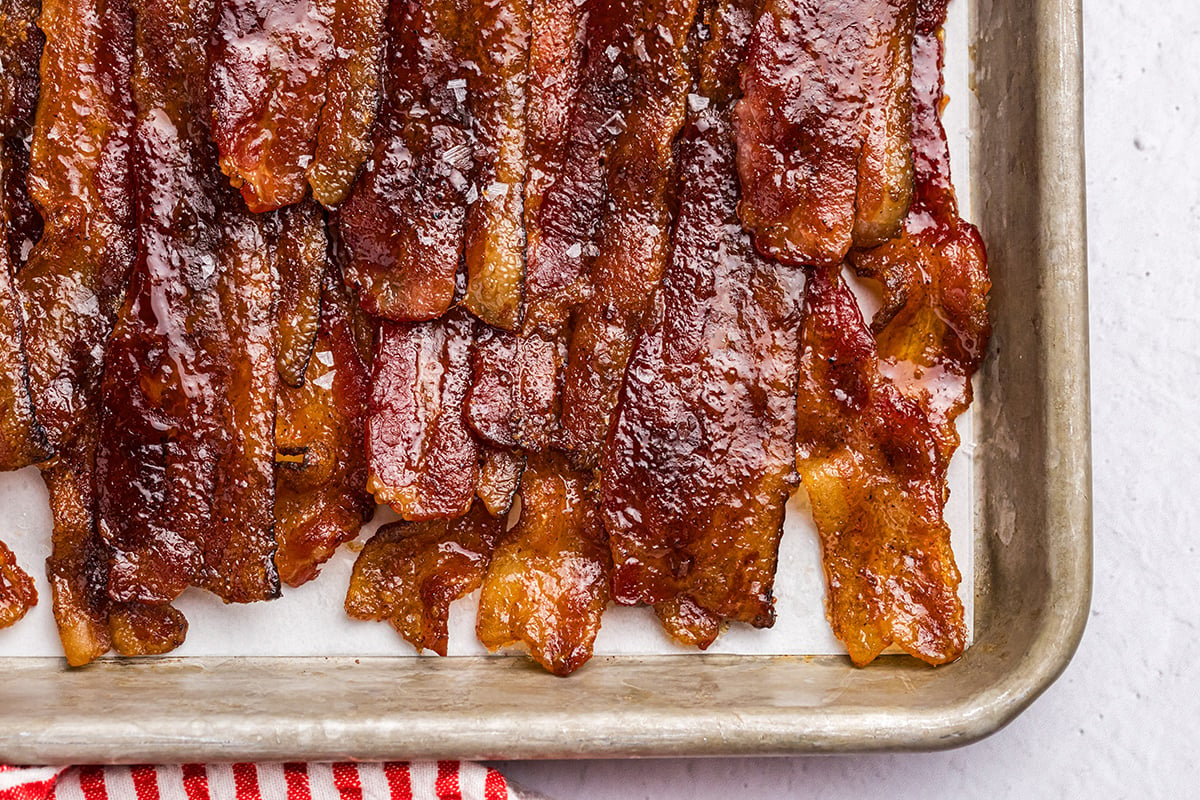 close up overhead shot of candied bacon on parchment paper line baking sheet