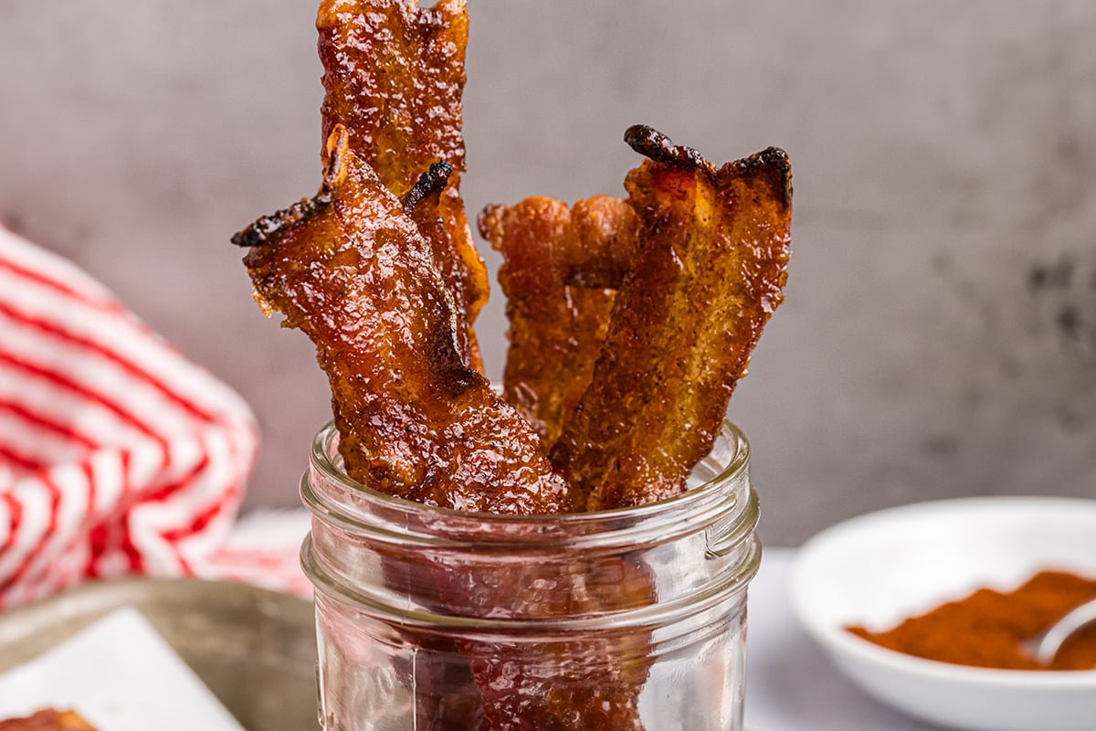 close up straight on shot of candied bacon in jar