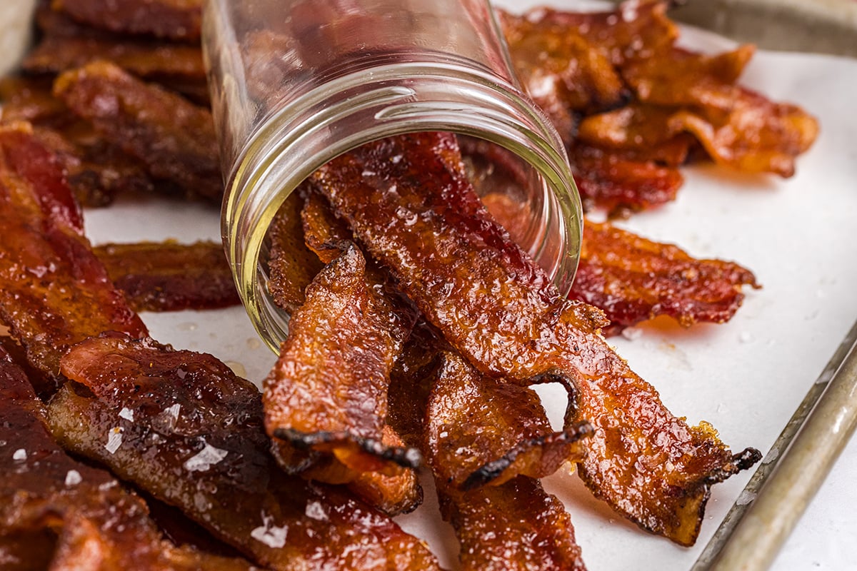 straight on shot of candied bacon poured out of mason jar