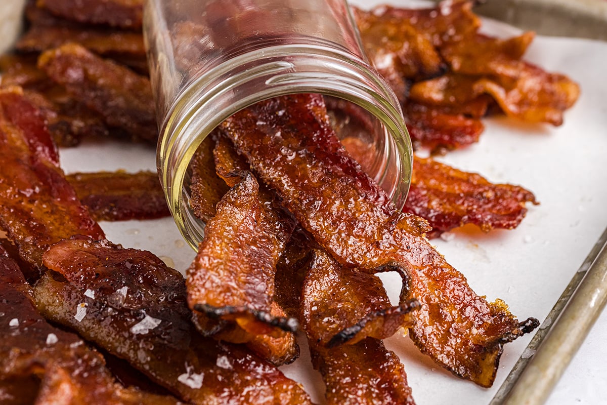straight on shot of candied bacon poured out of mason jar