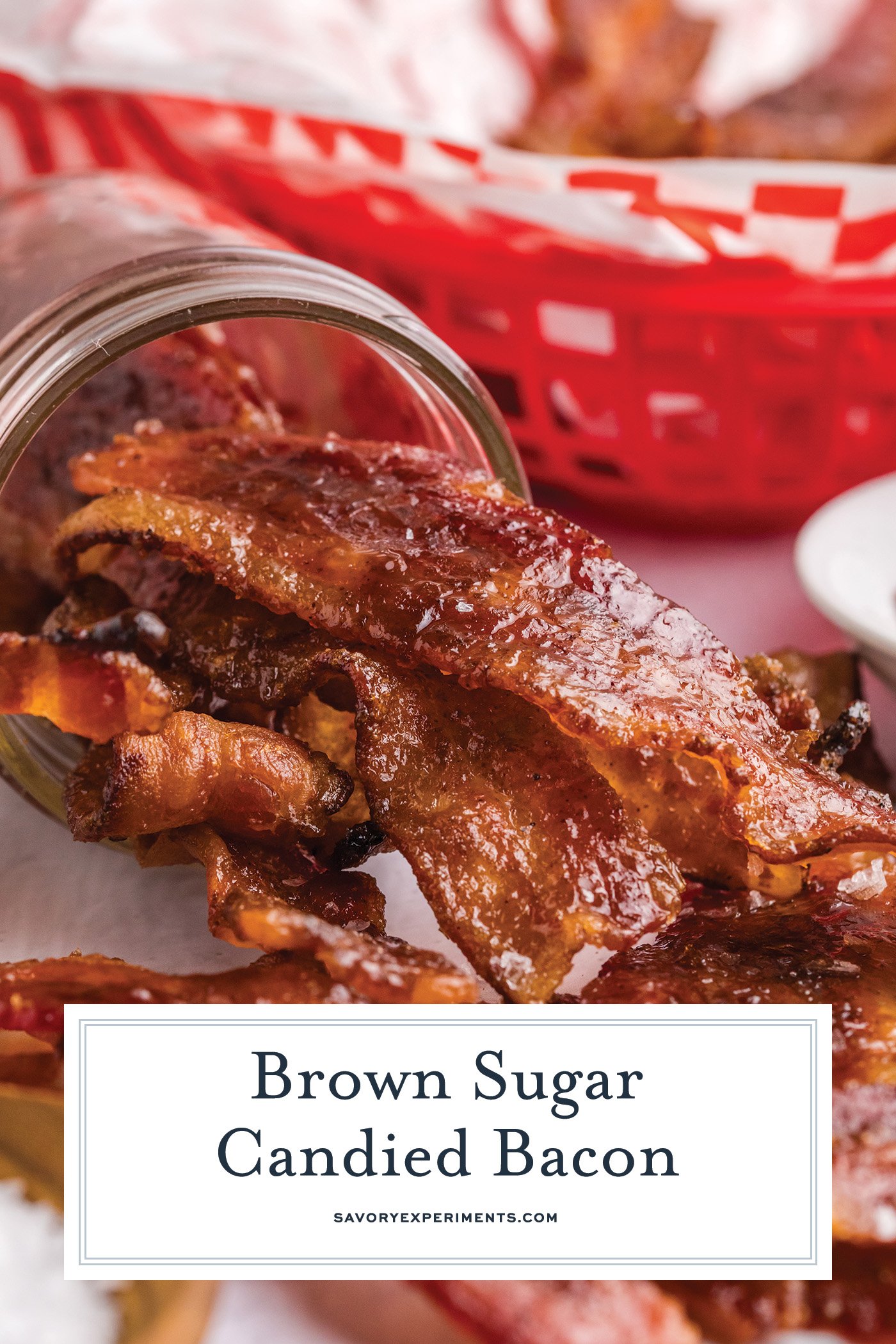 straight on shot of candied bacon in tipped over jar