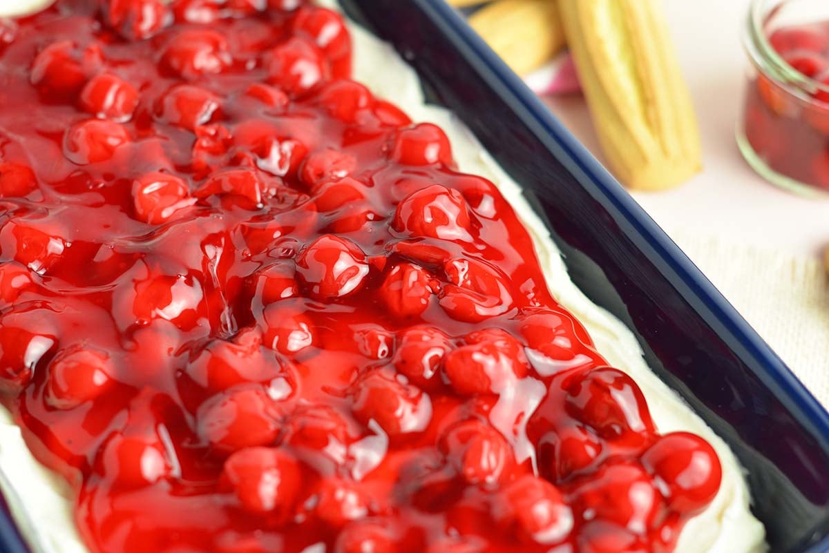 angled view of cherries on top of a dip