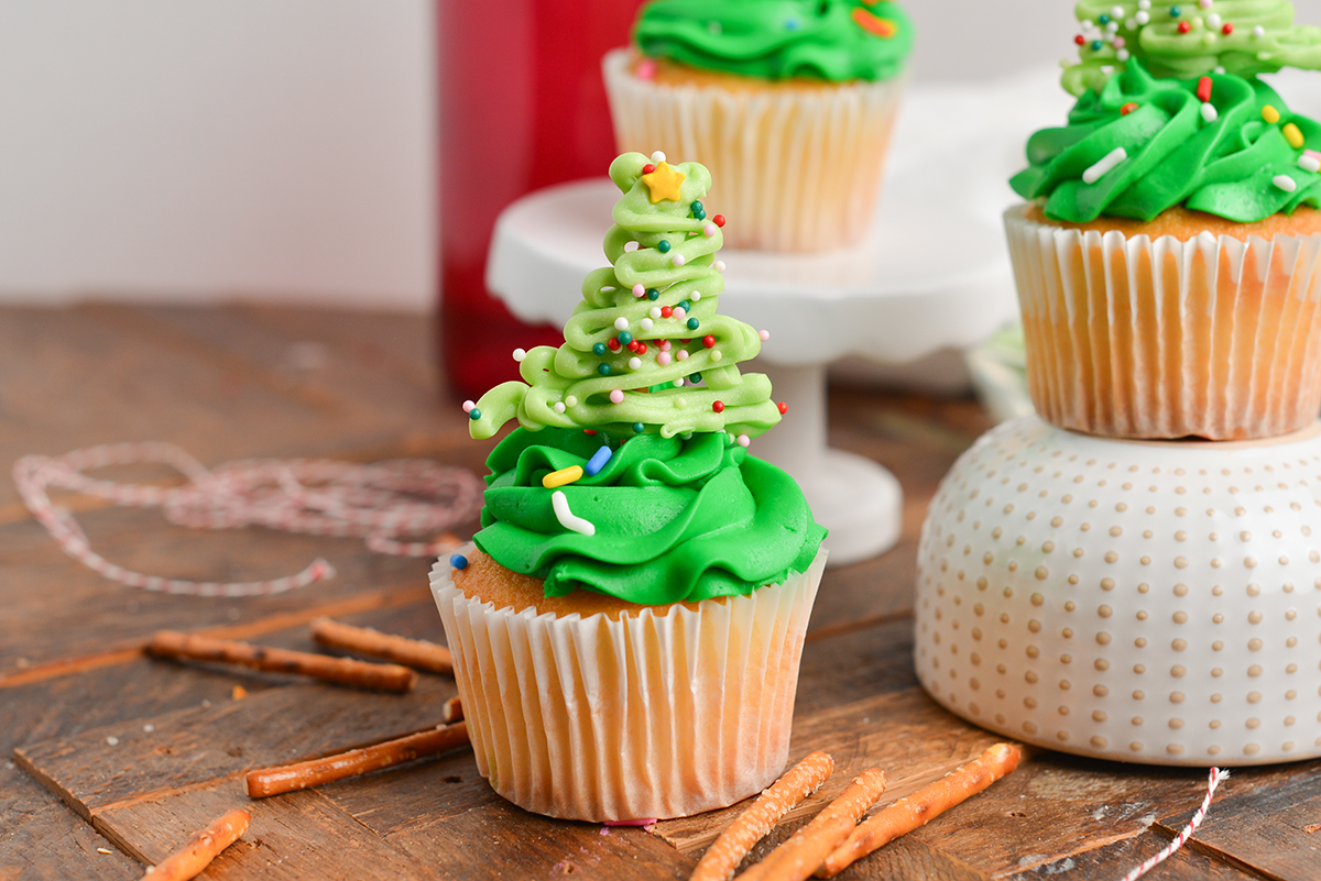 cupcakes decorated with christmas trees and sprinkles